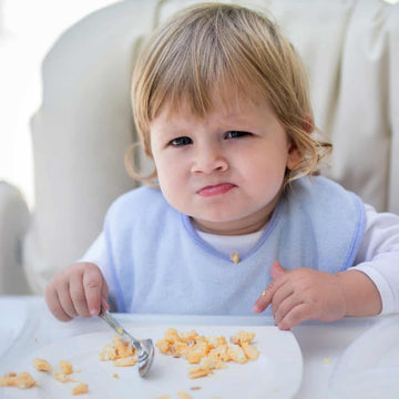 a kid eating egg